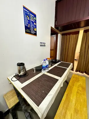 a kitchen with a table with mats on it at K K Gardens in Palakkad