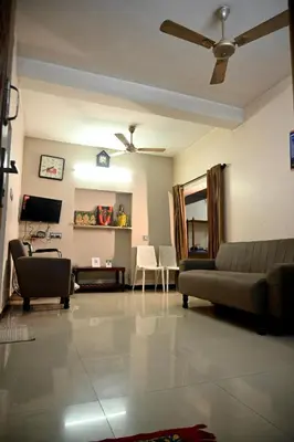 a living room with a couch and a tv at K K Gardens in Palakkad