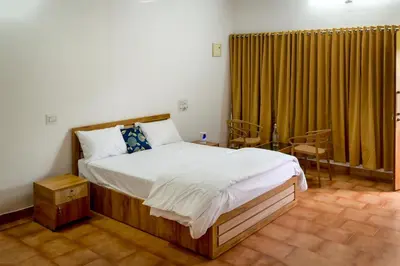 a bedroom with a large bed in a room at Cozy Haven Homestay in Meenangadi