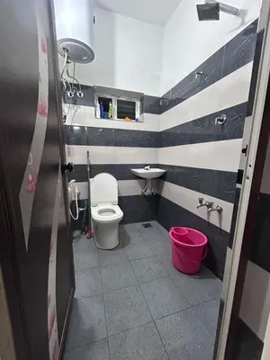 a bathroom with a toilet and a sink at Wild Villa Homestay in Sultan Bathery