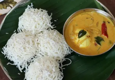 a plate of rice and a bowl of curry at Wild Villa Homestay in Sultan Bathery