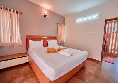 a bedroom with a bed with two towels on it at Cucuu Nest Villa Coonoor by VOYE HOMES - Surrounded by Tea Plantations in Coonoor