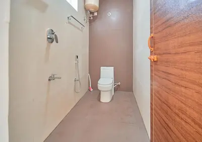 a bathroom with a toilet and a shower at Cucuu Nest Villa Coonoor by VOYE HOMES - Surrounded by Tea Plantations in Coonoor