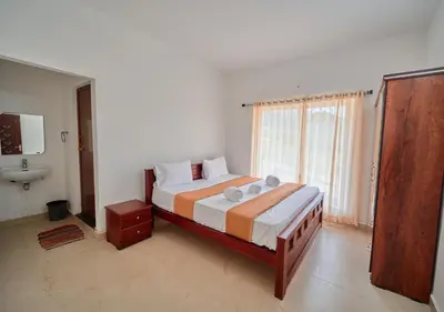 a bedroom with a bed with a sink and a window at Cucuu Nest Villa Coonoor by VOYE HOMES - Surrounded by Tea Plantations in Coonoor