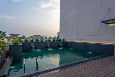 a swimming pool on the roof of a building at Park Inn & Suites by Radisson Thrissur East Fort in Trichūr