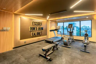 a gym with treadmills and exercise equipment in a building at Park Inn & Suites by Radisson Thrissur East Fort in Trichūr