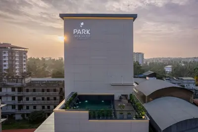 a building with a sign on the side of it at Park Inn & Suites by Radisson Thrissur East Fort in Trichūr
