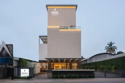 a large white building with a sign on it at Park Inn & Suites by Radisson Thrissur East Fort in Trichūr