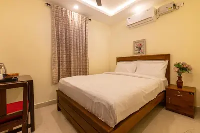 a bedroom with a bed and a window at The Modern Inn in Pollāchi