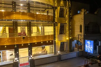 a building with lights on the side of it at The Modern Inn in Pollāchi