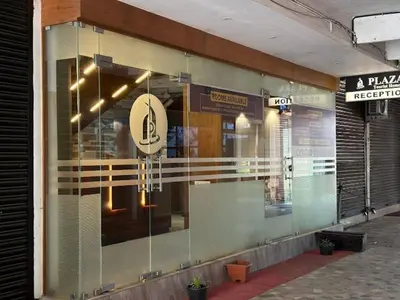a window of a store with a sign on it at PLAZA RESIDENCY and CONFERENCE HALL in Malappuram