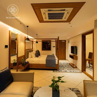 a hotel room with a bed and a couch at Mazarine Hotels & Resorts LLP in Kalpetta