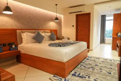 a bedroom with a large bed in a room at Mazarine Hotels & Resorts LLP in Kalpetta