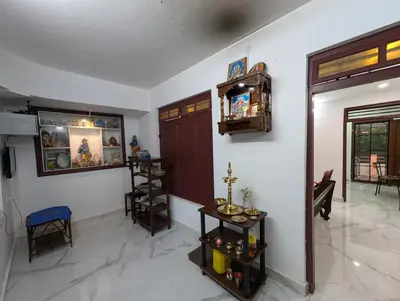 a living room with a door and a table at Thekkumkattil Villa in Nedumbassery