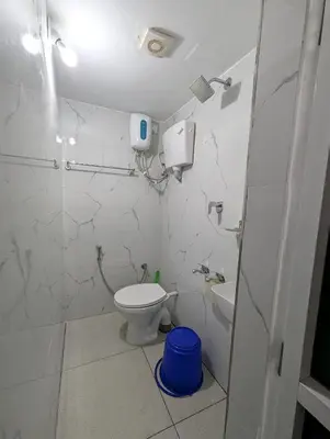 a bathroom with a toilet and a sink at Thekkumkattil Villa in Nedumbassery