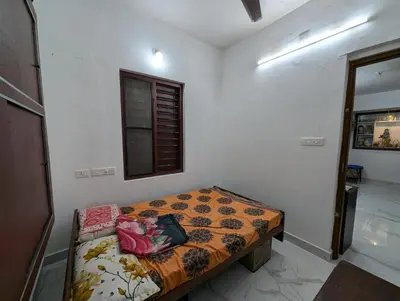 a bedroom with a bed in a room with a window at Thekkumkattil Villa in Nedumbassery