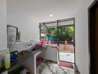 a kitchen with a sink and a large window at Thekkumkattil Villa in Nedumbassery