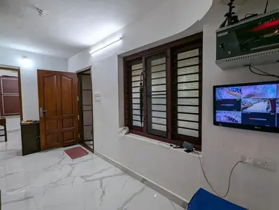 a room with a flat screen tv on a wall at Thekkumkattil Villa in Nedumbassery