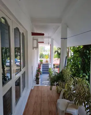 an empty hallway of a house with plants at GURI Homestay in Kushālnagar