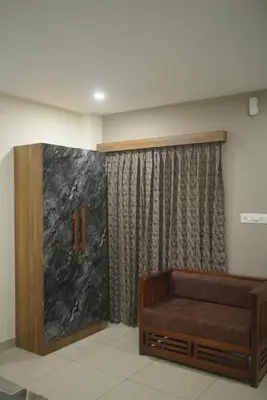 a waiting room with a bench and a curtain at Cruz Inn calicut in Kozhikode