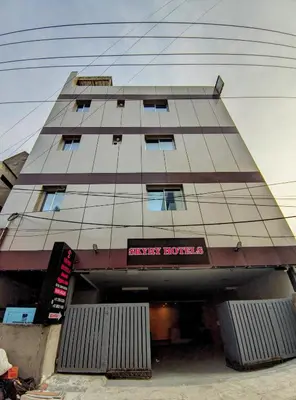 a tall building with a sign on the front of it at Skyry Hotels Singanallur in Coimbatore