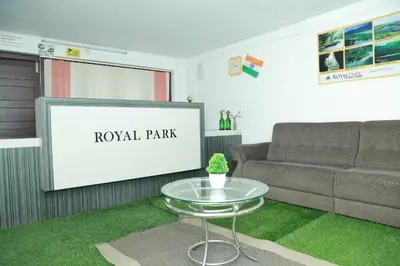 a living room with a couch and a table at Royal Park in Wayanad
