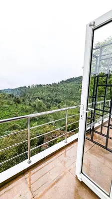 an open door to a balcony with a view at VALLEY VIEW INN, Kotagiri in Kotagiri