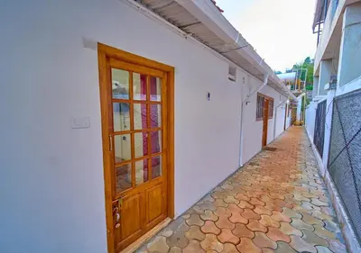 an empty alley with a wooden door on a building at Shivvs Heritage Resort Ooty in Ooty