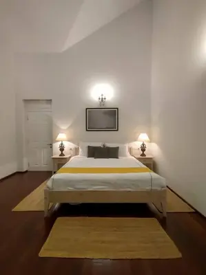 a bedroom with a large bed with two night stands at Hideaway in Ooty