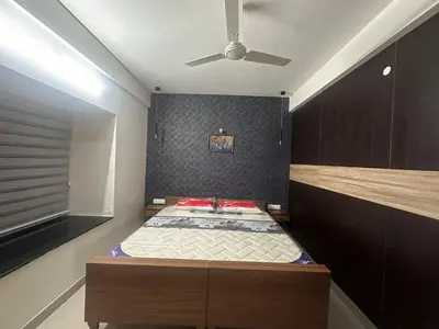 a bedroom with a bed with a ceiling fan at CC Family in Guruvāyūr
