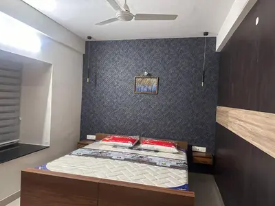a bedroom with a bed and a ceiling fan at CC Family in Guruvāyūr