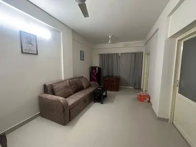 a living room with a chair and a couch at CC Family in Guruvāyūr