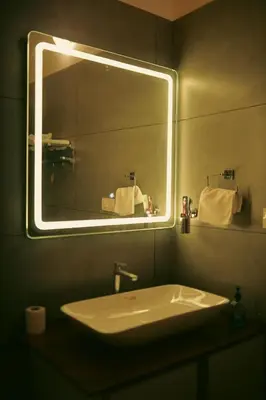 a bathroom with a sink and a large mirror at SR Villa - Serenity by riverside in Meppādi