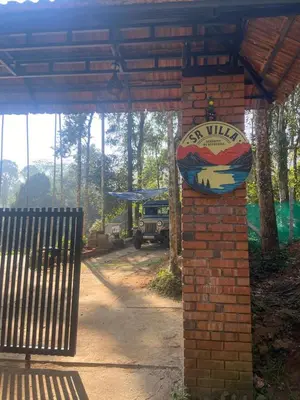 a brick pillar with a sign on it at SR Villa - Serenity by riverside in Meppādi