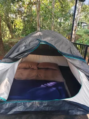a tent with a bed in it at SR Villa - Serenity by riverside in Meppādi
