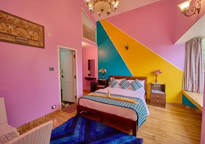 a bedroom with colorful walls and a bed at EMYs Misty Charm Private Villa Ooty by VOYE HOMES in Ooty