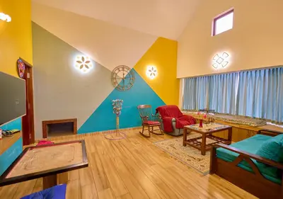 a living room with a couch and a table at EMYs Misty Charm Private Villa Ooty by VOYE HOMES in Ooty