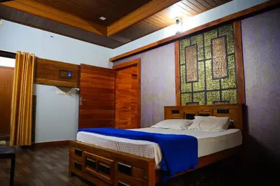 a bedroom with a bed with a large window at The Rain Tree resort in Kutta
