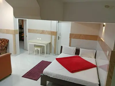 a bedroom with a bed with a red blanket on it at The silver dale homestay 1 in Ooty