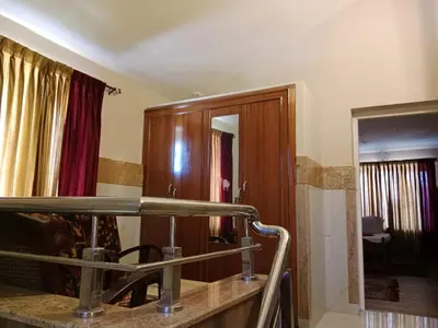a bathroom with a wooden cabinet and a mirror at The silver dale homestay 1 in Ooty