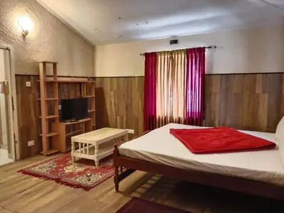 a bedroom with a bed with a red towel on it at The silver dale homestay 1 in Ooty