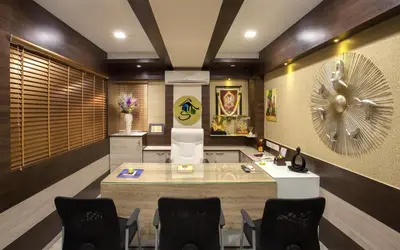 a lobby with a reception desk and chairs at Ananyas Nest in Coimbatore