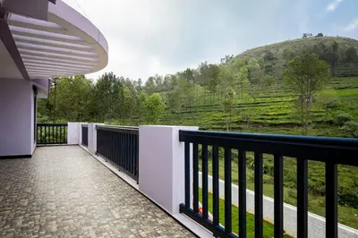 a balcony with a view of a mountain at Haven inn in Kotagiri
