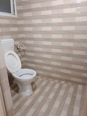 a bathroom with a white toilet in a room at Bethany stay in Ooty