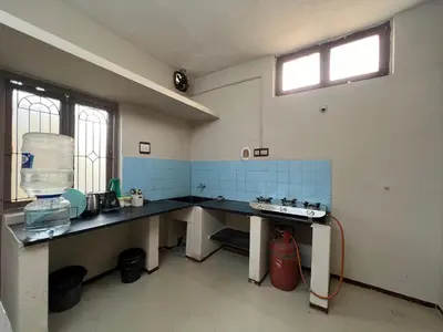 a kitchen with a counter and a sink in it at SHI's 2BHK home in Coimbatore near Sai Baba Colony, Ganga C Hospital, Women's care in Coimbatore
