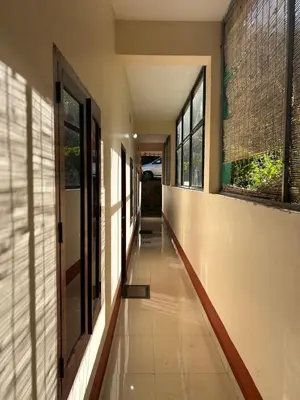 an empty hallway of a building with windows at GV Royal Residency Vattavada in Vattavada