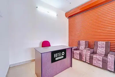 a meeting room with two chairs and a table at Super Hotel O Viswapuram in Coimbatore