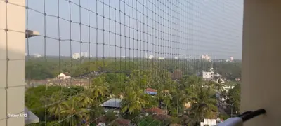 a view of a city from a window with trees at Seashells Pentagon Calicutbeach in Kozhikode