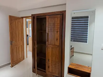 a wooden cabinet in a room with a window at Seashells Pentagon Calicutbeach in Kozhikode