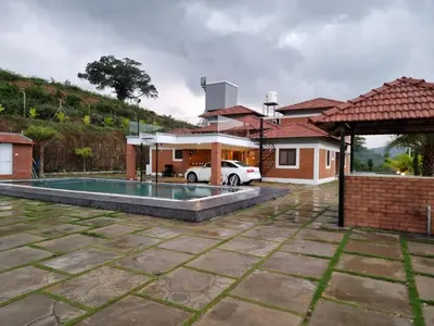 a house with a swimming pool in a yard at KK Selfie Point Resort in Coimbatore